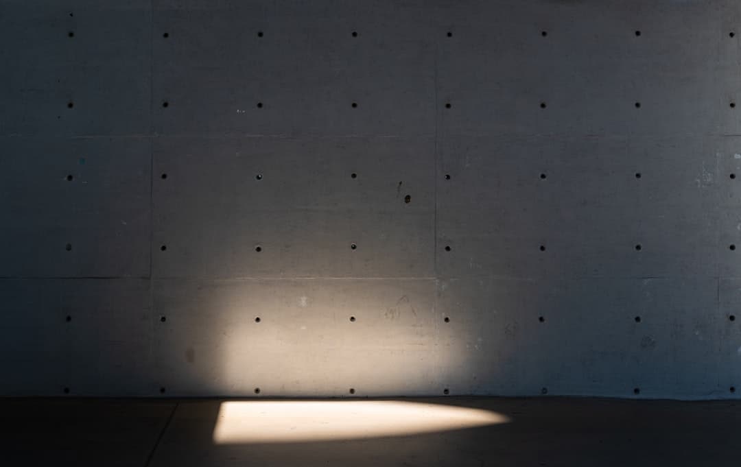 Sunlight illuminates a textured wall and floor.