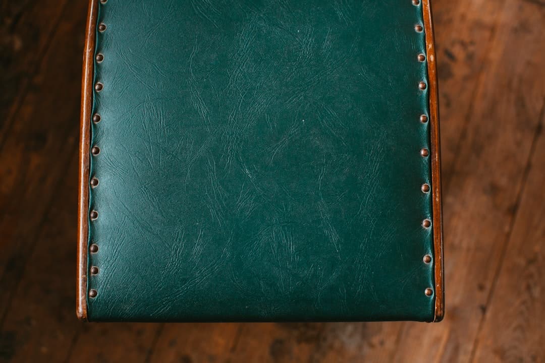 green leather wallet on brown wooden table